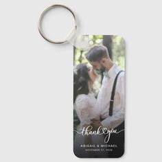 a keychain with an image of a couple holding each other and the words thank you