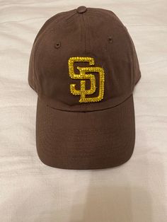 adjustable crystal embellished San Diego padres hat. San Diego Padres Aesthetic, Sports Dad Hat With Logo Patch, Snapback, Beige Six-panel Baseball Cap With Embroidered Logo, San Diego Padres Hat, San Diego Padres, Trucker Cap, San Diego, Caps Hats, Accessories Hats