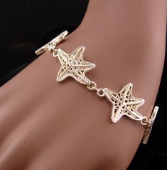 This beautiful never worn starfish bracelet would make a great gift for the ocean lover. IT is thick and well made and would be perfect for your favorite mermaid! 12-2-20 Ocean-inspired Bracelet With Starfish Charm, Metal Starfish Jewelry, Ocean-inspired Starfish Charm Bracelet, Adjustable Starfish Charm Jewelry, Elegant Starfish Bracelet For Gift, Starfish Charm Bracelet As Gift, Star-shaped Bracelet With Starfish Charm Gift, Elegant Starfish Bracelets For Beach, Silver Starfish Bracelet For Gift