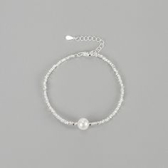 Elevate your wrist with our stunning Natural Pearl Sterling Silver Bracelet. Crafted with genuine pearls and high-quality sterling silver, this bracelet exudes elegance and sophistication. The natural pearls add a touch of luxury, making it a perfect accessory for special occasions or everyday wear. Embrace timeless beauty with this exquisite bracelet that will effortlessly enhance your style. Material: 925 Sterling Silver Stone: 8mm Natural Freshwater Pearl Length: 16+3cm Minimalist Sterling Silver Pearl Bracelet With Charm, Dainty Silver Bracelet With Pearl Chain, Adjustable Sterling Silver Pearl Charm Bracelet, Pearl White Bracelets With Pearl Drop For Party, Pearl White Bracelet With Pearl Drop For Party, Pearl Bracelets With Pearl Charm For Parties, Minimalist Silver Pearl Chain Bracelet, Party Pearl White Bracelets With Pearl Charm, Silver Pearl Bracelet With Pearl Drop For Gift