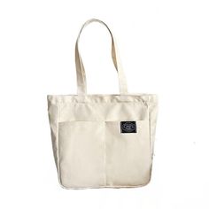 Introducing our Women's Canvas Tote Bag, a perfect blend of style and practicality for the modern woman. Crafted with high-quality cotton, this designer handbag is a versatile accessory that effortlessly transitions from casual outings to beachside adventures. With its solid color design, this tote bag exudes understated elegance. The spacious interior offers a large capacity, allowing you to carry all your essentials and more. Its durable construction ensures it can withstand the demands of eve Trendy Bag With Canvas Lining And Double Handle, Trendy Cotton Bag With Large Capacity, Trendy Large Capacity Cotton Bag, Eco-friendly Canvas Bag With Pockets, Eco-friendly Canvas Bags With Pockets, Trendy Canvas Hobo Bag In Tote Shape, Casual Shoulder Bag For Daily Use With Canvas Lining, Trendy Canvas Hobo Tote Bag, Trendy Large Capacity Cotton Hobo Bag