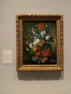 a painting is hanging on the wall in a museum