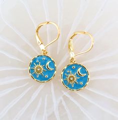 Moon Sun Gold Earrings. Shine like the sun and reflect the mystique of the moon with these exquisite gold earrings. These celestial-inspired dangle earrings are the perfect gift for the jewelry lover in your life. The blue and gold combination adds a touch of elegance to any outfit, making them ideal for both casual wear and special occasions.  Featured in a turquoise blue with gold leverback ear wires.  Treat yourself or surprise a friend with these enchanting earrings by Mystic Pieces.  Give a gift of the stars. *SIZE* Length is 1.25 inches Width is .50 inches *FREE SHIPPING* I will get your lovely in the mail within 24 to 48 hours.  Shipping is Monday through Friday and mailed USPS first class or priority mail. Tracking number will be sent to you. For more delights from Mystic Pieces: G Blue Moon-shaped Sterling Silver Earrings, Hypoallergenic Celestial Round Earrings, Celestial Nickel-free Earrings As Gift, Celestial Nickel-free Earrings For Gifts, Blue Spiritual Earrings For Gifts, Nickel-free Celestial Earrings Gift, Blue Moon Shaped Sterling Silver Earrings, Celestial Style Hypoallergenic Drop Earrings, Blue Sterling Silver Sun And Moon Jewelry