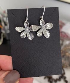 "Sterling silver flower dangle earrings are finished with sterling silver lever backs for a secure wear.  These earrings make a sweet gift for a nature lover, gardener or a special girl on any occasion. The earrings measure approx 1.5\" from end to end and are approx 1\" wide. You may also like to check out more of my earrings here: http://etsy.me/2oDJlWy Free USPS First Class shipping within the USA."