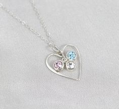 "A cluster of birthstones, nestled in a Sterling Silver heart, makes a meaningful gift for Mom or Grandma. TO ORDER -- Please select the number of birthstones and the finished length that you would like from the drop down menus. Please include the birthstone order that you would like in the personalization box. The Sterling Silver heart measures 24 x 18mm ( just under 1\" by 5/8\") and the birthstones are just under 1/4\". This necklace will hold up to three birthstones inside the Sterling Silve Sterling Silver Heart-shaped Birthstone Necklace, Birthstone Necklace For Birthday And Valentine's Day, Valentine's Day Birthday Birthstone Necklace, Mother's Day Heart-shaped Sterling Silver Birthstone Necklace, Heart-shaped May Birthstone Necklace Gift, Mother's Day Heart Cut Birthstone Necklace With Heart Charm, Personalized Heart Birthstone Necklace For Wedding, Heart-shaped Birthstone Necklace For Weddings And Mother's Day, Heart-shaped Birthstone Necklace For Wedding And Mother's Day