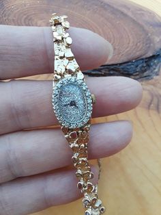 "ATTENTION BUYERS.. PLEASE READ ANNOUNCEMENT IN MY SHOP. it's very important information there about purchasing items. Must purchase thru Etsy only, NOT from \" Offsite ads\"Absolutely Stunning 14k Yellow Gold Diamond Lady's Wrist Watch... Perfect Vintage Pre Owned Condition. Watch stamped 14k gold. All appraximately, my Estimate.. I am not Gemologist. All sales are final.. Some pics ENLARGED to see details Weight 25.35 Grams Safety Chain on The Side. For less then 7 inches Wrist.ATTENTION BUYER Gold Round Diamond Watch Gift, Timeless Gold Diamond Watch As Gift, Luxury Gold Watches, Luxury Anniversary Watch, Yellow Gold Diamond Watch With Round Dial For Anniversary, Round Dial Jewelry With Polished Finish For Anniversary, Gold Round Diamond Watch For Formal Occasions, Yellow Gold Diamond Jewelry And Watches As Gift, 14k Yellow Gold Jewelry With Diamond Hour Markers