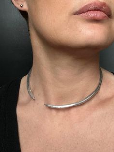 A minimalist and refined design for this timeless necklace, made from 5 mm diameter aluminum wire, shaped and hammered by hand. This semi-rigid bangle necklace will adapt to your current style...rock, chic, or even shock, depending on the position you give it. >>One size Aluminum is a very light material, resembling silver in terms of shine, but which does not oxidize over time, even in contact with water. Each Nat K piece is unique because it is handcrafted to order. it is therefore possible that the item delivered is slightly different from that of the photo. Style Rock Chic, Torque Necklace, Classical Wedding, Timeless Necklace, Style Rock, Rock Chic, Silver Choker, Current Styles, Brass Necklace