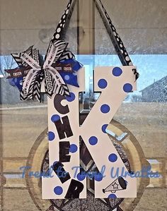 the letter k is decorated with blue and white polka dots, as well as a bow