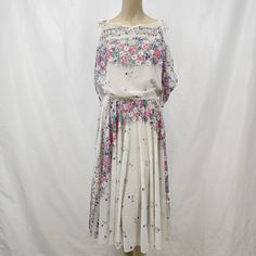 This stunning Zum Zum dress from the 1970s is a must-have for any vintage fashion lover! Made in the USA, this dress features a beautiful pattern and a flattering fit for sizes 9/10. It's perfect for any occasion, from a groovy 70s-themed party to a night out on the town. Don't miss your chance to own a piece of fashion history! Vintage Midi Dress For Spring Garden Party, Vintage Midi Dress For Garden Party In Spring, Mid-century Floral Print Dress For Spring, Vintage Flowy Midi Dress For Daywear, Flowy Vintage Midi Dress For Daywear, Mid-century Floral Print Spring Dress, 1950s Vintage Dress With Summer Pattern, 1950s Vintage Dress For Summer, 1950s Style Vintage Dress For Summer