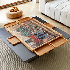 a coffee table with drawers on top of it in front of a couch and rug