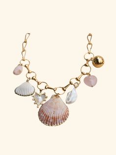 Dive into summer with this enchanting Mermaid Charm Necklace, a perfect blend of natural shells, lustrous pearls, and soothing rose quartz. Adorned with specialty charms, each element intertwines beautifully to create a whimsical and elegant accessory. Ideal for beach outings or adding a touch of seaside magic to your everyday look, this necklace is the ultimate summer statement piece. 18 inches in length Beaded Ideas, Mermaid Pin, Mermaid Accessories, Body Necklace Chain, Handmade Stuff, Whimsical Jewelry, Mermaid Jewelry, Mermaid Necklace, Trendy Necklaces