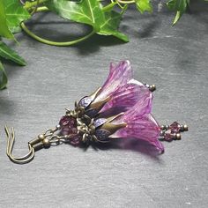 PINK FLOWER FAIRY EARRINGS ▪️▪️▪️▪️▪️▪️▪️️▪️▪️▪️▪️▪️▪️ Inspired by the delicacy of butterfly wings the hand painted flowers used in these feminine  handmade earrings combine shades of pink and gold. Antique bronze floral bead caps add a vintage feel and amethyst crystal drops sway gently when they move. These beautiful feminine earrings are very light weight and as my earring hooks are always sourced as lead, nickel and cadmium free they are perfect for sensitive ears.     💜MATERIALS *Antique Bronze Tone Findings  *Lucite Flowers *Glass Crystals 💜DIMENSIONS *cm drop ▪️▪️▪️▪️▪️▪️▪️️▪️▪️▪️▪️▪️▪️ 💜For more fairy flower earrings take a look here, https://www.etsy.com/uk/shop/BohoFlowerDesign?section_id=28583823   💜All my accessories are lovingly handcrafted and made to order. My designs ar Handmade Purple Flower Earrings Whimsical Style, Purple Handmade Whimsical Flower Earrings, Handmade Purple Whimsical Flower Earrings, Handmade Purple Fairycore Jewelry, Purple Bohemian Flower Earrings For Gift, Handmade Vintage Purple Flower Earrings, Purple Bohemian Flower Earrings As Gift, Bohemian Purple Flower Earrings For Gifts, Purple Flower Bohemian Earrings