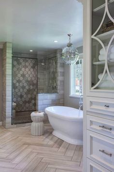 a bathroom with a tub, toilet and sink in it's center piece is shown