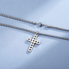 Wear your faith proudly with this men's cross necklace. This beautiful statement piece is crafted in sterling silver with 14k white gold plating and sits on a sturdy 24-inch gold plated stainless steel chain. Gift this bold black cross pendant to him and showcases your faith and belief. Discover all our sleek 925 silver jewelry for men and find a gift for him HERE Made with white gold plated 925 sterling silver. Color: White Dimension: 38 x 25 x 3 mm Length: 60 cm/ 23.6 Inches Chain: 60cm/ 24 In Father's Day Stainless Steel Cross Pendant Necklace, Father's Day Stainless Steel Cross Necklace, Silver Cross Pendant Necklace For Father's Day, White Gold Stainless Steel Cross Pendant Necklace, White Gold Stainless Steel Cross Necklace, Father's Day Silver Cross Pendant Necklace, Stainless Steel Cross Pendant Necklace With Box Chain, Stainless Steel Cross Pendant Jewelry, Tarnish Resistant, Tarnish Resistant Stainless Steel Cross Pendant Jewelry