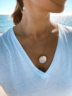 Great summer accessory for ocean lovers! Made of the real shell found on the beaches of Marbella in Spain. Decorated with natural mini pearls. Chain is gold plated 925 silver. Measures 60 cm. Handmade in Spain. Strand Shell Necklace With Pearl Charm As Gift, Pearl Charm Shell Necklace Strand As Gift, Beach Jewelry With Pearl Pendant In Shell Shape, Dainty Pearl Necklaces For The Beach, Gold Necklace With Pearl Pendant For Summer, Summer Gold Pearl Necklace With Pendant, Gold Pearl Chain Jewelry For Vacation, Beach Shell Pendant Necklace With Pearl Charm, Beach Pendant Necklace With Pearl Charm