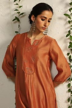 Spice orange kurta with placement leaf hand embroidery and scalloped sheer panelled sleeves. Paired with scalloped edge pant and embroidered dupatta.
Components: 3
Pattern: Embroidered
Type Of Work: Nakshi, Zari
Neckline: Notched
Sleeve Type: Scallop
Fabric: Kurta and Dupatta: Chanderi, Pant: Cotton Satin, Lining: Cotton
Color: Orange
Other Details: 
Length:
Kurta: 43 inches
Pant: 36 inches
Dupatta (LXW): 90 X 20 inches
Occasion: Puja - Aza Fashions Satin Dupatta, Simple Kurtis, Chudidhar Neck Designs, Kurta And Dupatta, Embroidered Leaf, Chanderi Dupatta, Kurta Patterns, Simple Kurta Designs, Upcycling Ideas