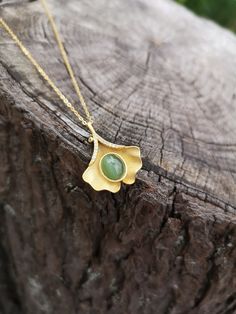 100% Genuine Natural Untreated Siberian Cats eye Nephrite Jade pendant with gold plated 925 silver. Beautiful Green Color, hand crafted.  This beautiful handcrafted necklace designed in a gorgeous leaf style with a modern twist.  It adds a bit of bohemian elegance to your everyday wear or to a special occasion. * Beautiful nephrite cat's eye. Very nicely shaped.  * Rare green nephrite with cat's eye effect, amazing stone, of superior quality.  * Please note that natural precious gemstones may in Handmade Yellow Gold Jade Necklaces, Nature-inspired Jade Pendant Necklace, Handmade Yellow Gold Jade Necklace, Jade Cabochon Pendant Necklace, Nature-inspired Gold Jade Jewelry, Handmade Elegant Leaf-shaped Necklace, Nature-inspired Jade Pendant Jewelry, Nature-inspired Gold Gemstone Necklaces, Nature-inspired Gold Necklace With Gemstone