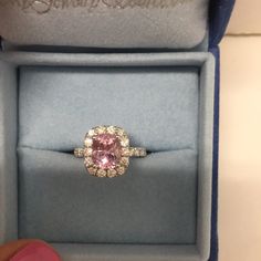 a pink diamond ring in a blue box