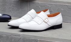 Style: 17007-8831-White Exclusive for C & E Fashions! Completely Handmade, this Matte Calfskin slip-on Loafer from the Ugo Vasare collection by Maurice features Goodyear Welted Construction, a Wingtip Design, Decorative Perforations, a Decorative Kiltie with Strap & Goldtone Buckle, and a full Leather Sole! Classic White Slip-ons With Flat Heel, White Closed Toe Slip-ons For Office, White Tassel Loafers With Leather Sole For Formal Occasions, Formal White Tassel Loafers With Leather Sole, Elegant Slip-ons For Spring Galas, White Tassel Loafers With Leather Sole For Business, White Slip-on Tassel Loafers For Formal Occasions, Elegant White Slip-ons For Office, White Round Toe Tassel Loafers For Galas