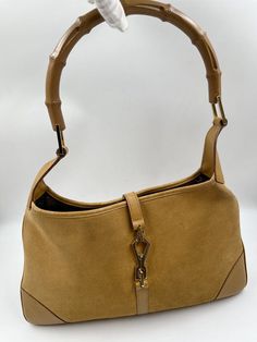 A stunning vintage Gucci Jackie bag made from a super soft suede, featuring gold hardware. and the iconic bamboo handle. Inside the bag is lined with brown cotton lining and there is a zipped pocket for valuables. This bag is in overall good vintage condition with some slight wear to the base edges and some marks to the suede. A true collectors item and the perfect summer bag. Vintage Gucci Jackie, Round Aesthetic, Villain Era, Fall Bags, Thrift Inspo, Bags And Totes, Summer Bag, Bamboo Handles, Nyc Apartment