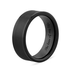 black ceramic wedding band with an inscription on it