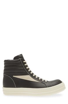 Crafted from full-grain leather and suede, this high-top sneaker is quintessentially Rick Owens with its blunted toe, dramatic lacing and shark-tooth sole. Drawing inspiration from vintage silhouettes and color schemes, this boldly topstitched shoe blends modern comfort with a timeless aesthetic. Lace-up style Leather upper and lining/rubber sole Made in Italy Designer Shoes Lace-up High-top Sneakers In Calf Leather For Streetwear, Lace-up High-top Calf Leather Sneakers For Streetwear, Sporty High-top Sneakers With Vulcanized Sole In Calf Leather, Calf Leather High-top Sneakers With Abzorb Midsole For Streetwear, Calf Leather High-top Sneakers With White Sole For Streetwear, Modern Calf Leather High-top Sneakers For Streetwear, Sporty Calf Leather High-top Sneakers, Designer Calf Leather High-top Sneakers For Streetwear, Designer Leather High-top Sneakers For Streetwear