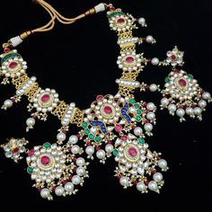 Kundan jewelry is 100% Handmade Indian Jewelry, best to wear it for traditional ceremonies or Indian weddings. This bridal jewelry has an ethnic finish. It has Polki Kundan stones with pearls in pink and green combinations. There are long and short patterns in Kundan jewelry. They give a glamorous outlook to traditional outfits. It has a Bollywood style to suit every occasion and goes really well with South and North Indian weddings. Color, shades, texture displayed may slightly vary from the ac Heavy Multicolor Traditional Wear, Ceremonial Multicolor Hand Set Bridal Necklace, Ceremonial Kundan Necklace With Intricate Design For Festivals, Heavy Multicolor Traditional Wear For Ceremonial, Ceremonial Kundan Choker With Intricate Design, Traditional Kundan Bridal Necklace For Diwali, Meenakari Bridal Necklace For Navratri Rituals, Bollywood Bridal Necklace With Intricate Design For Festivals, Traditional Multicolor Kundan Necklace For Rituals