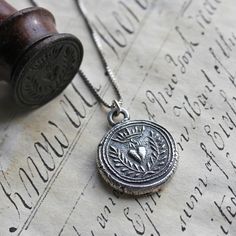 a wax seal with an animal head on it is sitting next to a wooden stamp