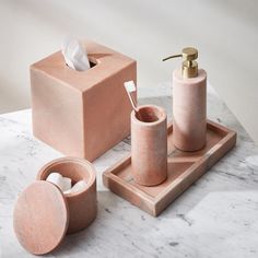 a bathroom set consisting of soap dispenser, toothbrush holder and cup