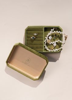 an open jewelry box sitting on top of a table