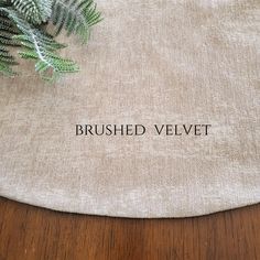 a close up of a table with a plant on it and the words brushed velvet