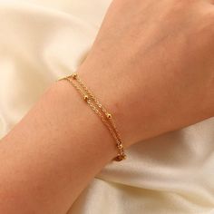 The Gemma Double Satellite Bracelet is a great layering piece, it is dainty but still makes a statement! With a youthful and contemporary feel, this adorable bracelet is a must-have for your stacking bracelet collection. Chain Length: 6 3/4" with a 1 1/4" extender 18K Gold Plated Stainless Steel Double Satellite Chain Water and Tarnish Resistant: Crafted to withstand everyday wear and tear Hypoallergenic: Made with high-quality materials and is safe for those with sensitive skin. Double Chain Bracelet Gold, Satellite Bracelet, Double Chain Bracelet, Gold Bracelet For Women, Double Chain, Gold Bracelet Chain, Stone Gold, Chain Gold, Cute Bracelets