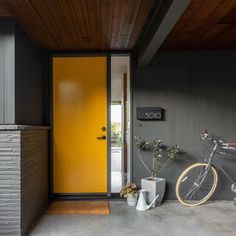 a bicycle is parked in front of a yellow door