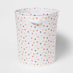 a white and multicolored polka dot storage bin