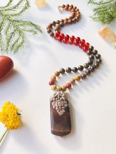 I make my own decisions with confidence and conviction. I allow my creativity to flow through me freely. I am confident in my ability to succeed. My sacral chakra is balanced. This purchase includes: Gemstone Half Mala, baggie, card including using your mala, intention setting and properties. GEMSTONES Rudraksha: Rudraksha seeds grow inside of what look like blueberries on trees in South East Asia. In Buddhism and Hinduism, the beads are believed to provide inner calm, peace, and free one from n Holistic Agate Gemstone Jewelry, Nature-inspired Agate Jewelry For Meditation, Healing Natural Stone Beaded Necklaces, Nature-inspired Beaded Necklaces For Healing With Natural Stones, Healing Natural Stones Beaded Necklace, Nature-inspired Gemstone Beaded Necklace For Wellness, Amber Amulet Jewelry For Meditation, Healing Natural Stone Beaded Pendant Necklace, Healing Natural Stone Pendant Beaded Necklace