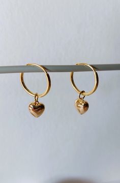 925 sterling silver gold plated hoop earrings, 14mm diameter, with an 18k gold plated heart. Length of the earring is 25 mm. The 18 carat gold filling is approx. 100 times thicker than with simple gold plating. The gold layer is mechanically bonded to the brass base material Goldfilled is resistant to abrasion under normal use. Small inclusions, color deviations and irregularities on the pearls or on the metals are part of the peculiarity of the materials. If you have special requests, want unusual pieces of jewelry, please feel free to contact me. More beautiful pieces of jewelry can be found here: https://www.etsy.com/de/shop/MerlesSchmuckArt Handmade Dainty Gold Huggie Earrings, Handmade Gold Dainty Huggie Earrings, Hoop Jewelry With Heart Charm For Anniversary, Small Hoop Earrings With Heart Charm For Anniversary, Small Hoop Jewelry With Heart Charm For Anniversary, Minimalist Hoop Earrings With Heart Charm For Anniversary, Gold Earrings With Heart Charm In 14k Gold Filled, Gold Sterling Silver Hoop Earrings For Gift, Gold Huggie Jewelry Gift For Her