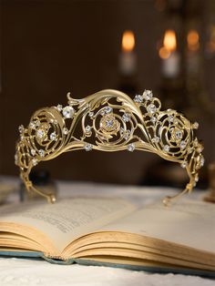 a gold tiara sitting on top of an open book