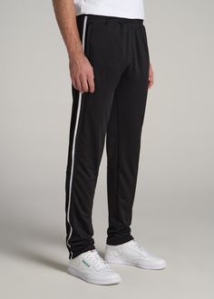 About Our Tall Men's Pants These men's tall athletic pants are a classic take on an athleisure essential. When it comes to athleisure, a good fit is key. You need something that's comfortable enough to relax in yet capable enough to work out in – but as a tall guy, it can be hard to find options that work for your height. You either have to compromise on a baggy fit or settle for lengths that are way too short. Not anymore. We know how hard it is to find quality styles when you're tall, which is Black Tapered Leg Activewear For Jogging, Black Tapered Leg Athleisure Activewear, Sportswear Sweatpants With Straight Hem, Casual Sports Bottoms With Straight Hem, Black Tapered Leg Sweatpants In Athleisure Style, Black Tapered Leg Athleisure Sweatpants, Straight Hem Sportswear Sweatpants, Black Tapered Leg Activewear For Sports, Relaxed Fit Joggers With Side Stripes For Jogging