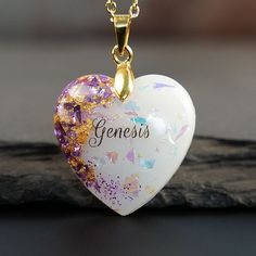 a heart shaped necklace with the word genens on it