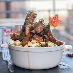 a white bowl filled with food on top of a table