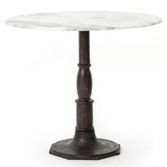 a white marble top dining table with an iron base