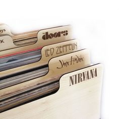 a stack of wooden records sitting next to each other on top of a white surface