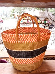 This is an African Sisal and Leather handbag or Planter Handmade in Kenya. It's made from Sisal Fibers and dyed in using natural dyes. It can be made with or without the leather handles depending on preference and use. Planters usually have the leather handles. It is used as a carry on handbag for your laptop, books or for clothes for an overnight stay.  Larger ones can be used for organizing your living room as storage for shawls or books. Larger ones can also be used as laundry baskets. They c Orange Handheld Beach Bag, Red Large Capacity Bucket Beach Bag, Red Straw Bag With Leather Handles For Daily Use, Large Capacity Red Bucket Beach Bag, Rectangular Orange Straw Bag With Handles, Red Shoulder Bag With Leather Handles For Market, Handmade Red Beach Bag For Everyday, Orange Woven Tote Bag, Orange Woven Bag For Shopping