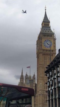 an airplane flying over big ben in london