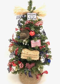 a small christmas tree decorated with red, white and blue ribbons