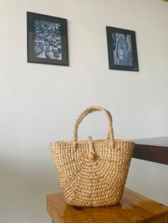 Let's support sustainability! Try our 100% handmade natural bag woven from water hyacinth. It's beautifully designed, durable, and combines style with sustainability. Crafted by skilled local artisans, our bags make a positive impact. Choose conscious fashion for a better future💚 What's special about this bag? * It preserves cultural heritage and local wisdom. * It is made by elderly individuals who want to earn some money during their free time at home. * It is 100% sustainable. * One bag prov Top Handle Natural Bucket Bag For Market, Natural Top Handle Bucket Bag For Market, Natural Woven Top Handle Beach Bag, Eco-friendly Jute Beach Bag With Top Handle, Handwoven Top Handle Beach Bag In Natural Fiber, Handwoven Natural Fiber Top Handle Beach Bag, Natural Fiber Top Handle Shoulder Bag In Natural Color, Natural Fiber Top Handle Shoulder Bag, Eco-friendly Top Handle Beach Bag For Vacation