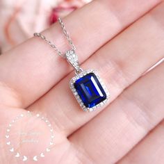 Unique on Etsy!  This is a beautiful necklace with a stunning Royal Blue coloured lab created genuine sapphire centre stone!  ''Hand made 3-carat eq. (7*9 mm) Royal Blue emerald cut lab created sapphire pendant, halo design with diamond simulants, comes with chain. '' When we first saw the finished sapphire cut we were over the moon! Our lab grown sapphire has the same chemical composition (mineral corundum), optical appearance and physical characteristics (Mohs scale 9) as top quality natural s Sapphire Jewelry Necklace, Physical Characteristics, Blue Emerald, Blue Sapphire Necklace, Mohs Scale, Halo Design, Silver Jewelry Necklace, Halo Pendant, Sapphire Pendant