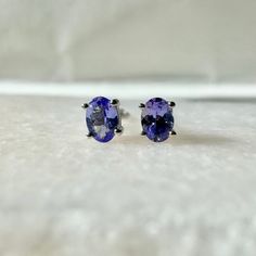 A timeless and classic design, symbolizing serenity, balance, and emotional healing. Perfect for everyday wear or dressed up for special occasions. Add a pop of color with our Genuine Tanzanite Oval Cut Stud Earrings, available in 14k solid white gold and 14k solid yellow gold. Item Specifications: Materials: 14k Solid Gold  Gemstone: Natural Tanzanite  Tanzanite Diameter: 4 mm x 3.3 mm Earring Posts Length: 10-11 mm  Total Gold Weight: 0.57 gram Total Tanzanite Weight: 0.38 ct Location: Earlobe Timeless Oval Everyday Earrings, Timeless Oval Earrings For Everyday, Oval Tanzanite Gemstone Earrings, Classic Oval Hypoallergenic Jewelry, Classic Hypoallergenic Oval Jewelry, Timeless Oval Gemstone Earrings, Classic Oval Hypoallergenic Earrings, Classic Tanzanite Gemstone Earrings, Oval Tanzanite Earrings