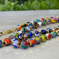 This authentic Murano Glass Millefiori Bead Necklace is a statement piece and is made in Italy - the country renowned for its world-class glassmaking traditions. Featuring a beautiful array of millefiori beads, each one painstakingly crafted by hand to create a truly unique piece of jewelry. The 24" chain hits mid-chest and has a simple claw closure. Millefiori Beads, Murano Italy, Murano Glass, Bead Necklace, Statement Pieces, Unique Pieces, Beaded Necklace, In Italy, Vibrant Colors