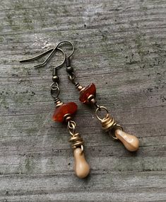 "Don't look now! Soon the seasons will be changing. The trees will shed their leaves as the earth goes into a season of rest.  With that in mind, these earrings were created with brown glass beads and copper pinecone charm. Each earring is  handmade to replicate one of my favorite seasons.  They are about 1.5\" in length and made with brass hardware. If you have any questions please feel free to message me anytime." Brown Czech Glass Teardrop Earrings, Nickel-free Brown Beaded Earrings With Czech Glass, Brown Czech Glass Beaded Drop Earrings, Brown Teardrop Czech Glass Jewelry, Nickel-free Brown Czech Glass Beaded Earrings, Vintage Brown Beaded Dangle Earrings, Brown Czech Glass Teardrop Jewelry, Earthy Brown Earrings With Dangling Beads, Earthy Brown Copper Earrings